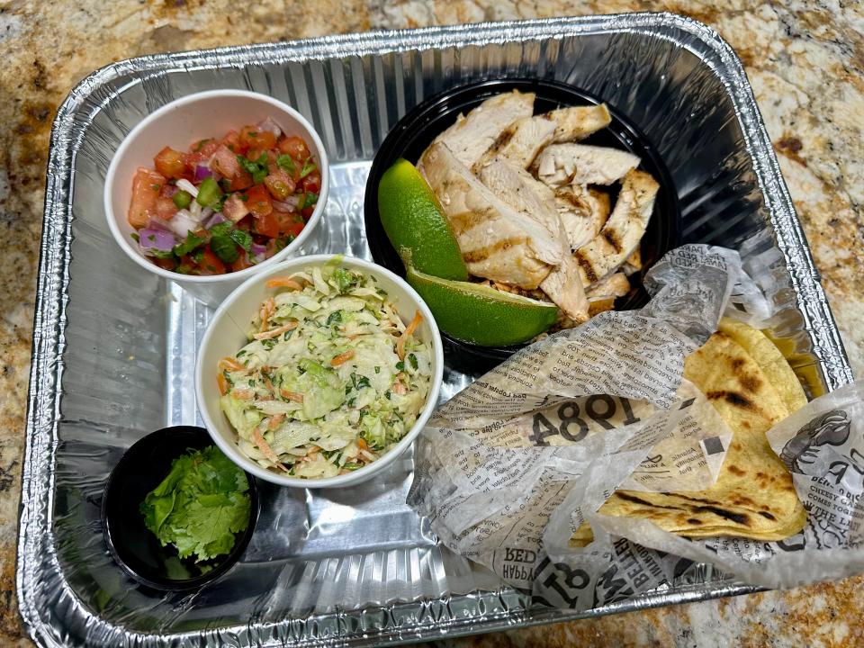 Pico de gallo, grilled chicken strips, tortillas, and cilantro in foil pan