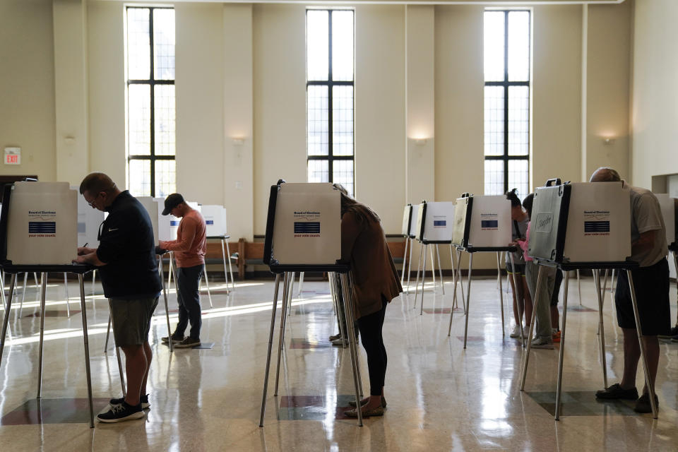 FILE - People vote on Election Day, Nov. 7, 2023, at Knox Presbyterian Church in Cincinnati. Voting rights advocates asked a federal judge on Friday, May 24, 2024, to strike down restrictions contained in Ohio's sweeping 2023 election law that they say restrict a host of trusted individuals from helping voters with disabilities cast absentee ballots. (AP Photo/Joshua A. Bickel, File)