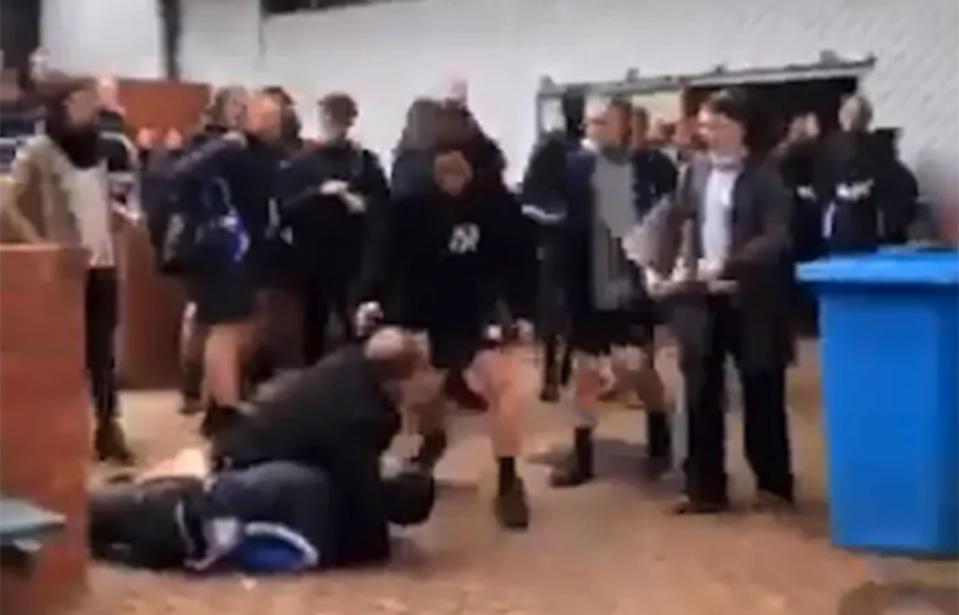 Mobile phone footage from a Berwick Secondary College brawl appears to show a teacher holding a student in a headlock. 