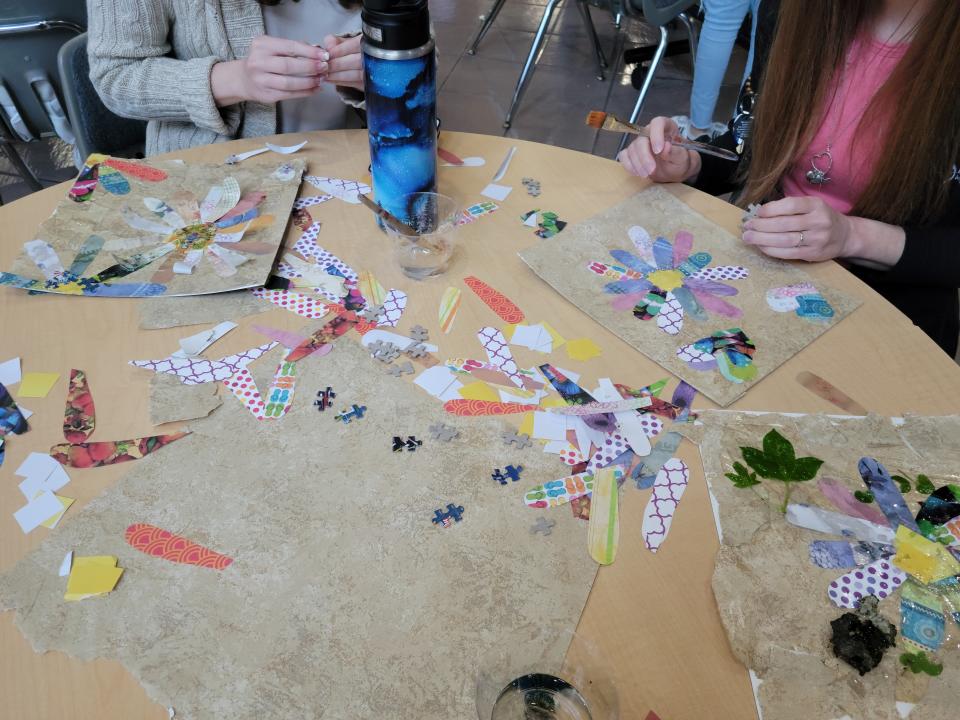 Students in one of Grant Manier's art classes learn how to use his art method of using recycled materials and clear glue to create eco-art collages.