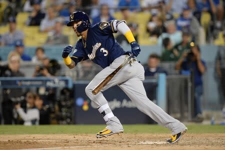 Oct 15, 2018; Los Angeles, CA, USA; Milwaukee Brewers shortstop Orlando Arcia (3) hits a single in the ninth inning against the Los Angeles Dodgers in game three of the 2018 NLCS playoff baseball series at Dodger Stadium. Mandatory Credit: Gary A. Vasquez-USA TODAY Sports