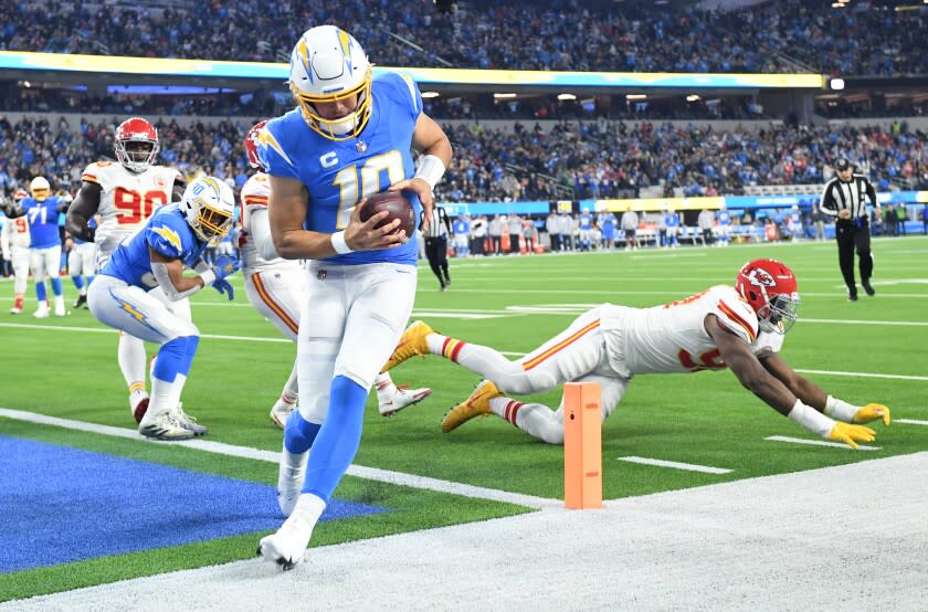 Inglewood, California December 16, 2021: Chargers quarterback Justin Herbert beats the Chiefs defense to score a touchdown in the second quarter at SoFi Stadium in Inglewood Thursday. (Wally Skalij/Los Angeles Times)