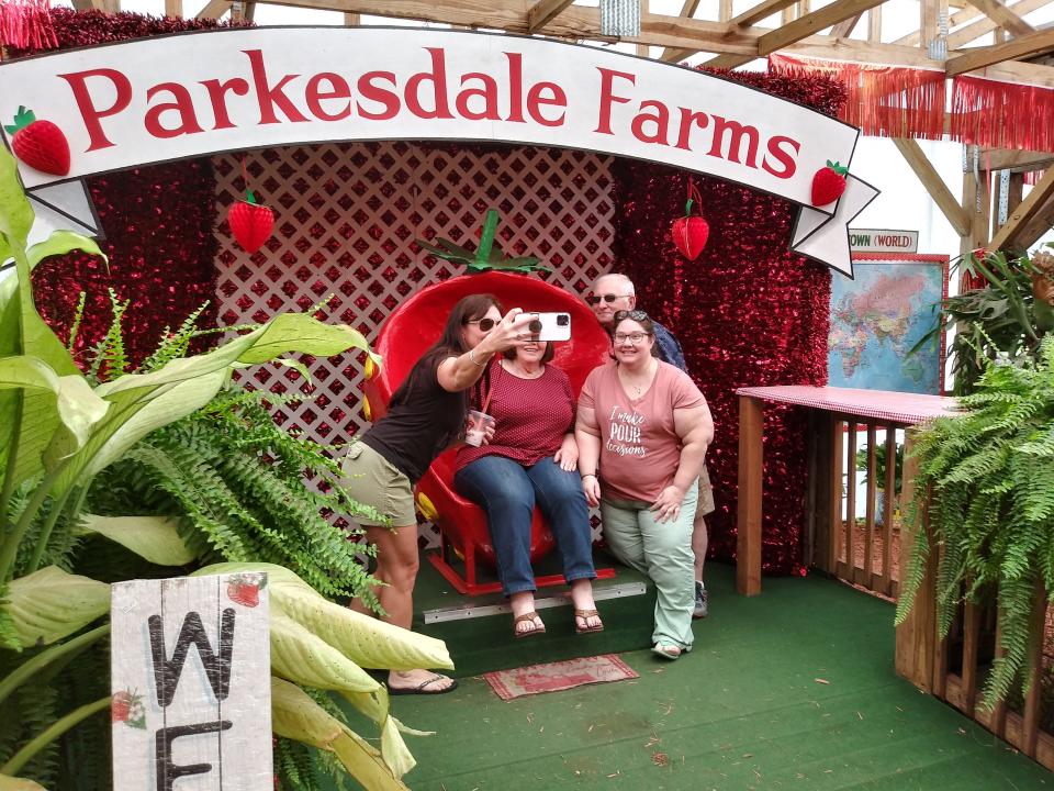 A family poses for a selfie in the "Garden of Eatin'" at Parkesdale Farms Market in Plant City. The market's famed seasonal menu item, strawberry shortcake, is available now through mid-April.