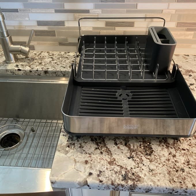 a reviewer photo of the dish rack next to a kitchen sink