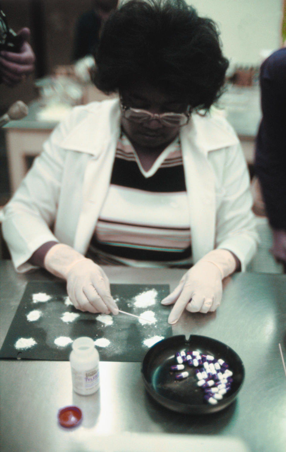 Lab technician testing Tylenol capsules. Source: Getty Images