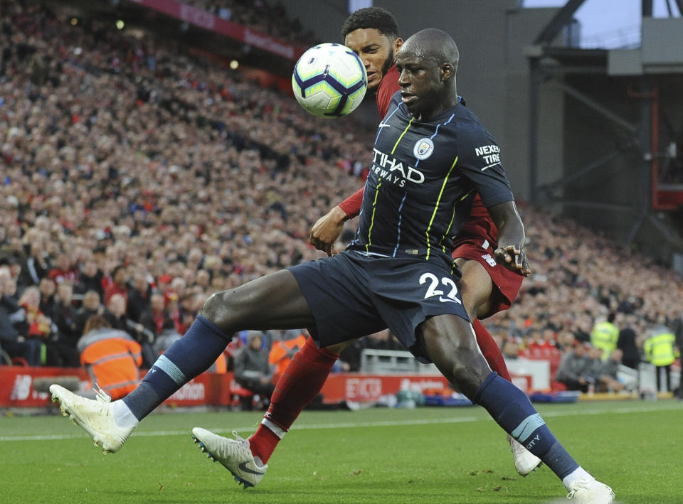Manchester City's Benjamin Mendy, front, and Liverpool's Joe Gomez vie for the ball during the English Premier League soccer match between Liverpool and Manchester City at Anfield stadium in Liverpool, England, Sunday, Oct. 7, 2018. (AP Photo/Rui Vieira)