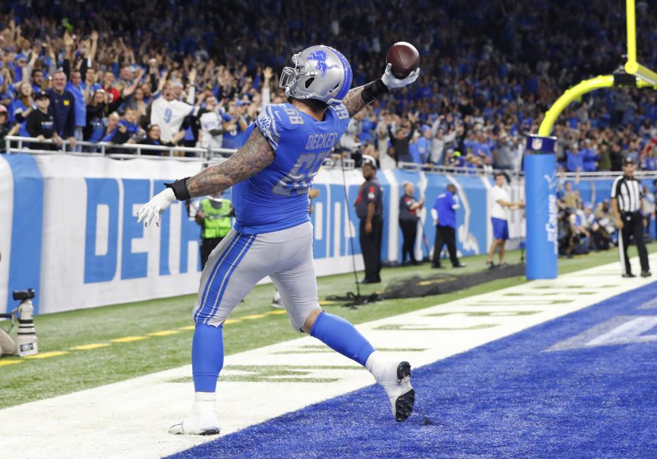 Detroit Lions offensive tackle Taylor Decker throws the ball to the fans after running 11-yards for a touchdown in a 2018 game. (AP Photo/Paul Sancya)