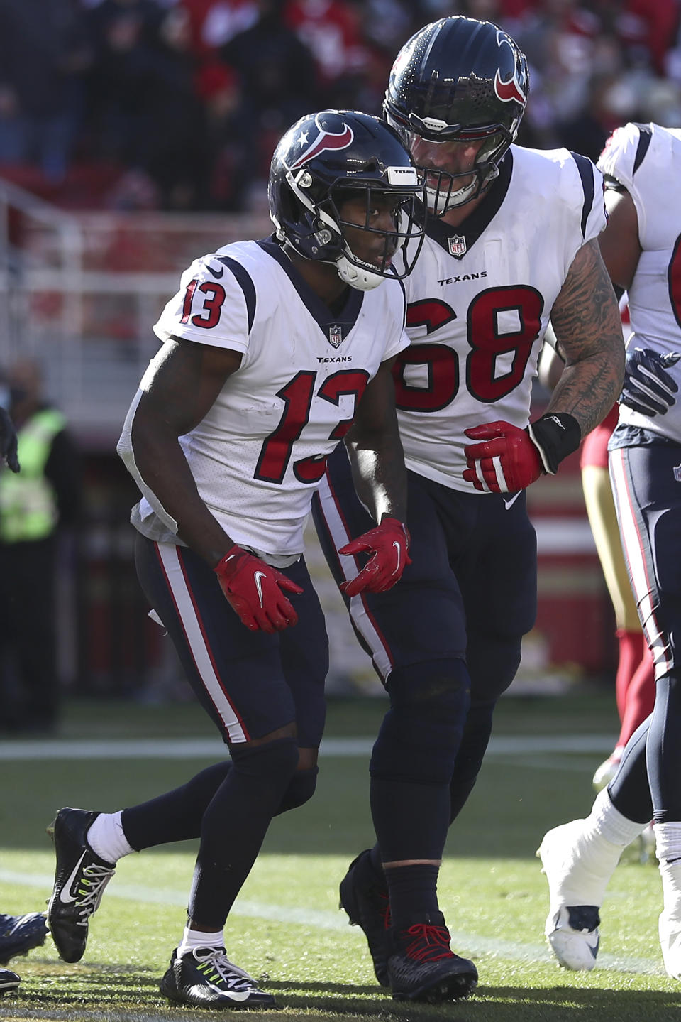 Houston Texans wide receiver Brandin Cooks (13) is congratulated by center Justin Britt (68) after scoring a touchdown against the San Francisco 49ers during the first half of an NFL football game in Santa Clara, Calif., Sunday, Jan. 2, 2022. (AP Photo/Jed Jacobsohn)