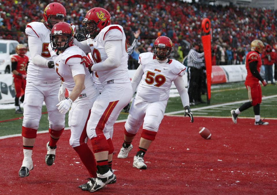 Jake Harty (6) and Sean McEwen (60) celebrated a 2013 touchdown against Laval. Both are now top CFL Draft prospects. (Mathieu Belanger/Reuters.)