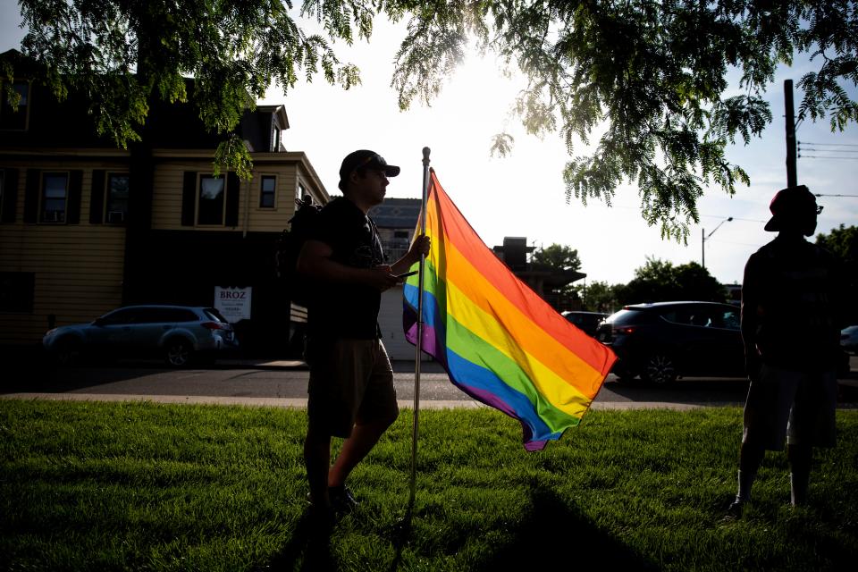 Quinn Marcotte holds a rainbow flag outside of Cheviot City Hall in support of the resolution to declare June 2022 as Pride month at the Cheviot City Council Committee Meeting on Tuesday, May 24, 2022. 