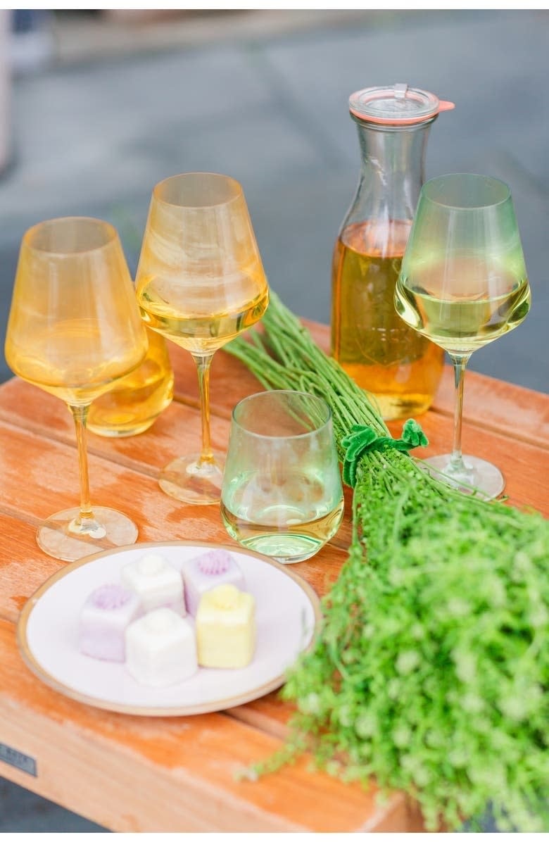 yellow wine glasses with wine on table