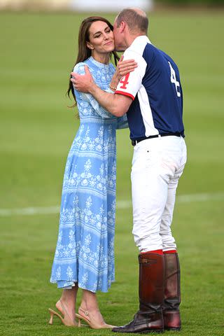 <p>Samir Hussein/WireImage</p> Kate Middleton and Prince William kiss at a charity polo game on July 6, 2023