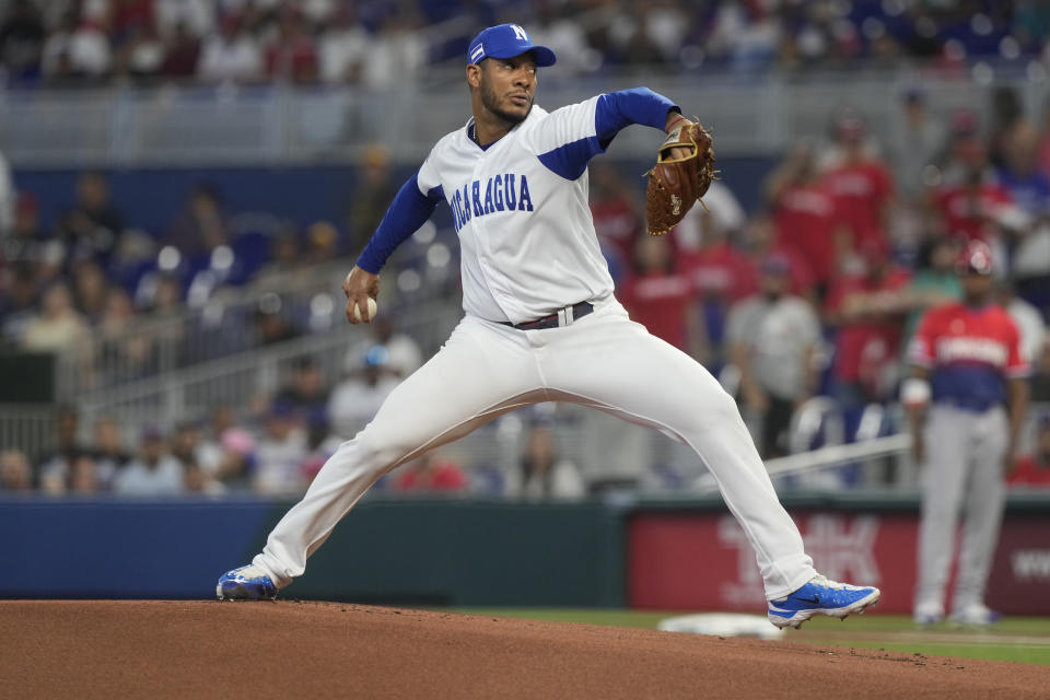 Nicaragua starting pitcher Juan Carlos Ramirez (66) aims a pitch during the first inning of a World Baseball Classic game against the Dominican Republic, Monday, March 13, 2023, in Miami. (AP Photo/Marta Lavandier)