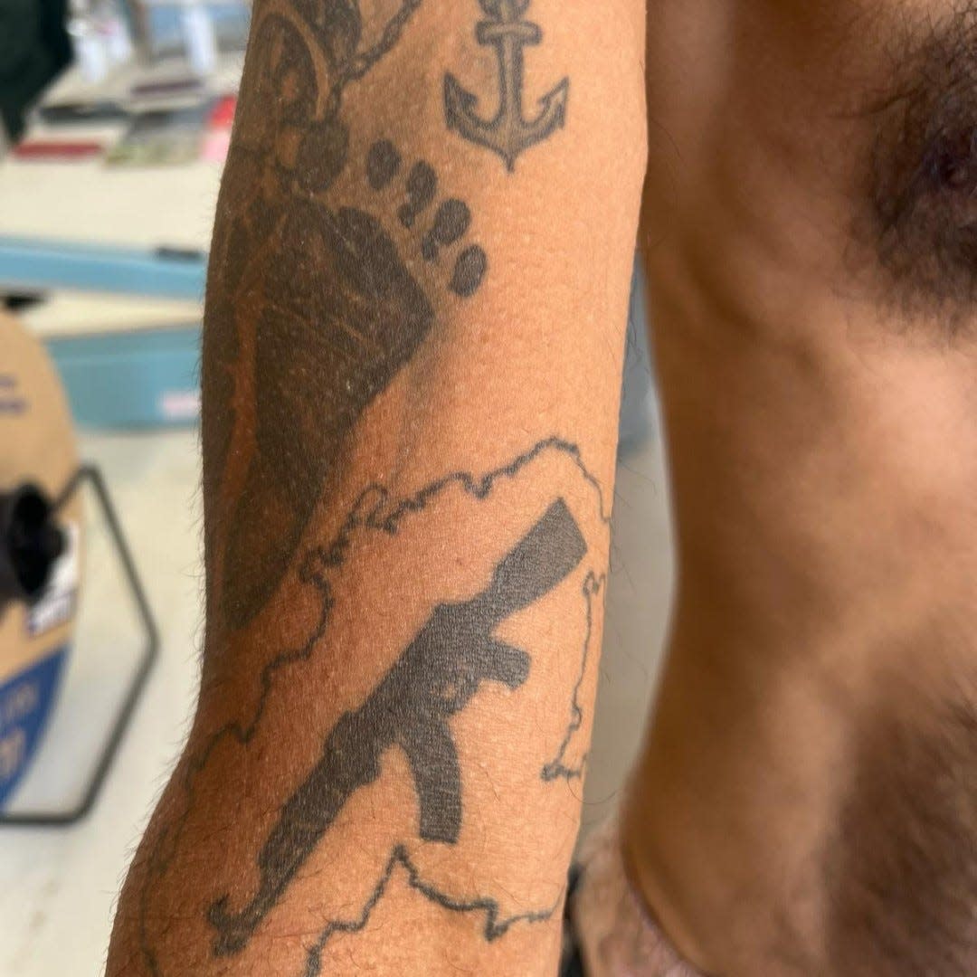 A tattoo of an AK-47 rifle associated with the Tren de Aragua gang from Venezuela is visible on the arm of Venezuelan migrant arrested by the U.S. Border Patrol in El Paso on April 3. The tattoo allegedly signifies a soldier for the gang.