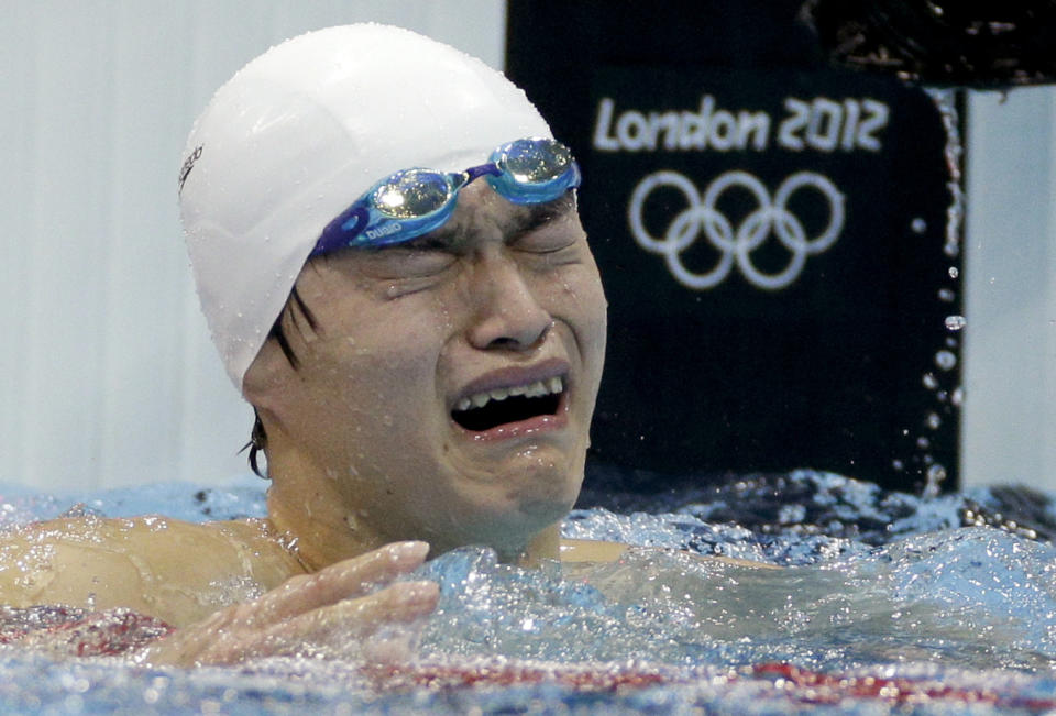 FILE - In this Saturday, Aug. 4, 2012 file photo, China's Sun Yang is overcome by emotion after his gold medal win in the men's 1500-meter freestyle swimming final at the Aquatics Centre in the Olympic Park during the 2012 Summer Olympics in London. One of China’s biggest Olympic stars will undergo a rare public trial of a doping case on Friday, Nov. 15, 2019 with his 2020 Tokyo Games place at stake. Three-time gold medalist swimmer Sun Yang is facing a World Anti-Doping Agency appeal in Switzerland that seeks to ban him for up eight years. (AP Photo/Michael Sohn, File)