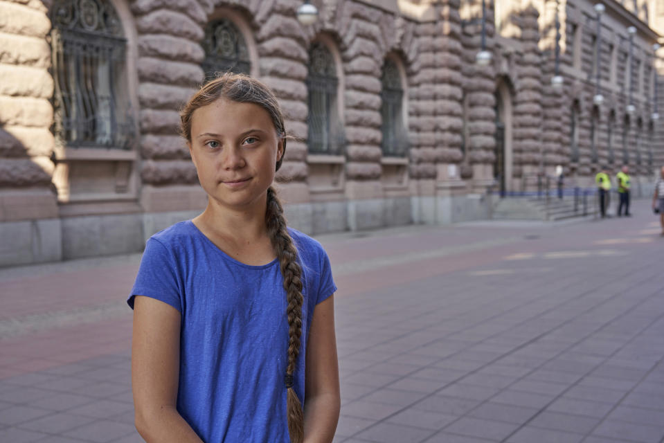 In this photo taken on Friday, July 26, 2019, Greta Thunberg stands next to Swedish parliament in Stockholm. Thunberg, the Swedish teenager whose social media-savvy brand of eco-activism has inspired tens of thousands of students in Europe to skip classes and protest for faster action against climate change, said Monday, July 29, 2019 that she plans to take her message to America the old-fashioned way: by boat. (AP Photo/David Keyton)