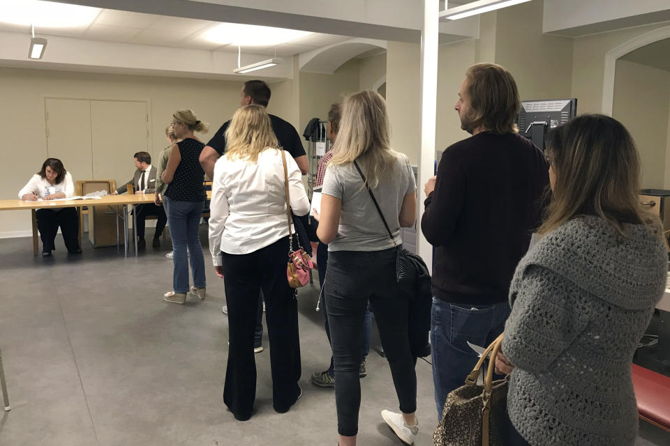 People queue up in a polling station to vote in Stockholm, Sweden, Sunday Sept. 9, 2018. Polls have opened in Sweden's general election in what is expected to be one of the most unpredictable and thrilling political races in Scandinavian country for decades amid heated discussion around top issue immigration. (AP Photo/Philipp Jenne)