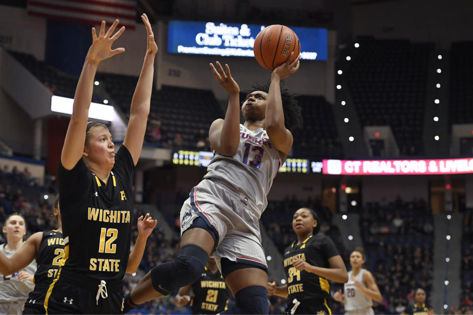 Connecticut's Christyn Williams (13) shoots over Wichita State's Carla Bremaud (12) during the first half of an NCAA college basketball game Thursday, Jan. 2, 2020, in Uncasville, Conn. (AP Photo/Jessica Hill)