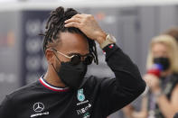 Mercedes driver Lewis Hamilton, of Britain, walks to a news conference before the Formula One U.S. Grand Prix auto race at the Circuit of the Americas, Thursday, Oct. 21, 2021, in Austin, Texas. (AP Photo/Darron Cummings)