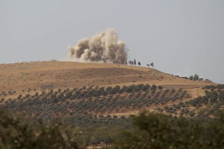 Smoke rises after what activists said were air strikes carried out by the Russian air force on Talat al-Sayyad, in the northern countryside of Hama, Syria October 14, 2015. REUTERS/Khalil Ashawi