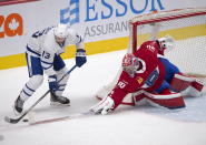 Laval Rocket goaltender Carey Price, right, poke-checks Toronto Marlies' Stefan Noesen during second-period American Hockey League action in Montreal, Monday, May 17, 2021. Price and Brendan Gallagher are on a one-game conditioning loan to the Rocket before their playoff series against the Toronto Maple Leafs. (Ryan Remiorz/The Canadian Press via AP)