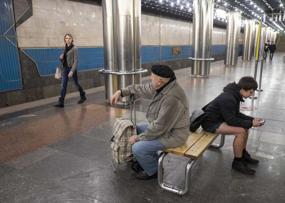 A passenger without pants waits on an underground platform during the "No Pants Subway Ride" in Kiev