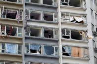 A man looks out from inside an apartment where some windows have been broken by typhoon Hato in Macau, China August 24, 2017. REUTERS/Tyrone Siu