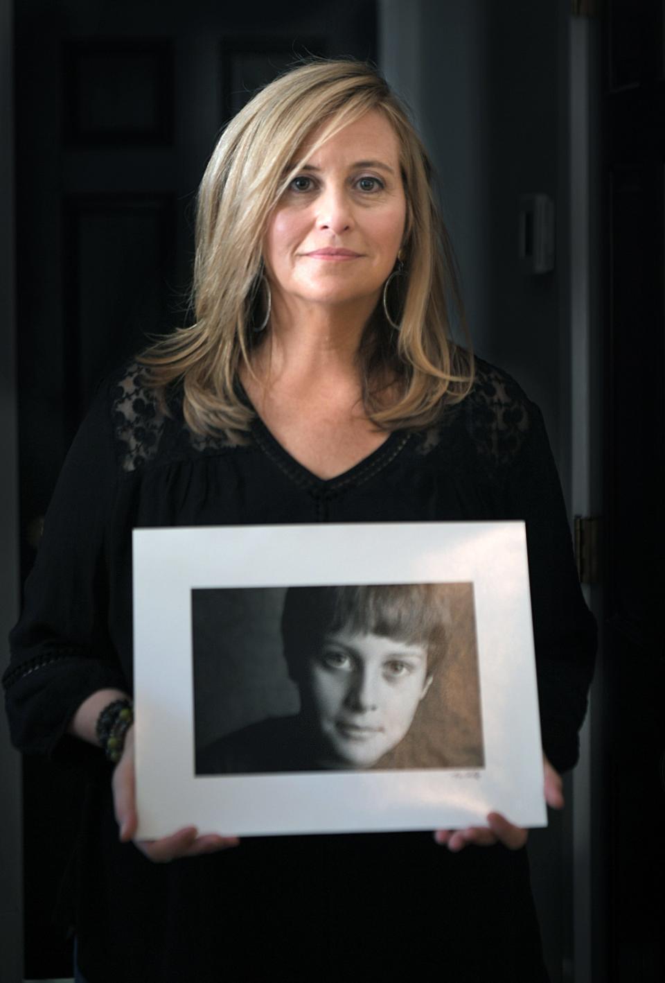 Former Mayor Megan Barry holds on her favorite childhood photograph of her son, Max, in her Nashville home on Thursday, August 22, 2019.  Max Barry died of a drug overdose at the age of 22.