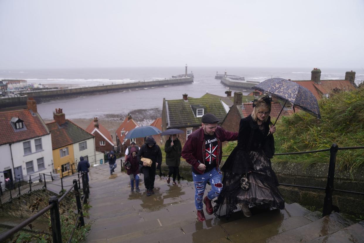 People braving the rain as they attend the Whitby Goth Weekend in Whitby, Yorkshire. (PA)