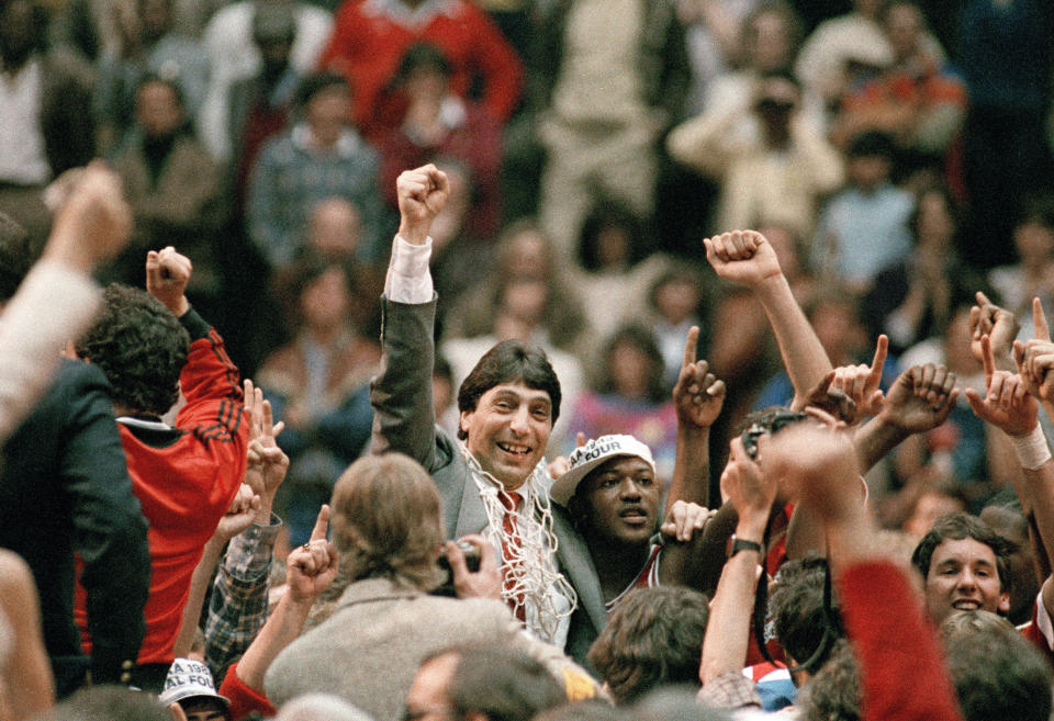 FILE - North Carolina State coach Jim Valvano, center with fist raised, celebrates after the team's win over Houston to win the NCAA men's college basketball tournament championship in Albuquerque, N.M., April 4, 1983. Ten players from North Carolina State’s 1983 national champion basketball team have sued the NCAA and the Collegiate Licensing Company seeking compensation for unauthorized use of their name, image and likeness. (AP Photo, File)