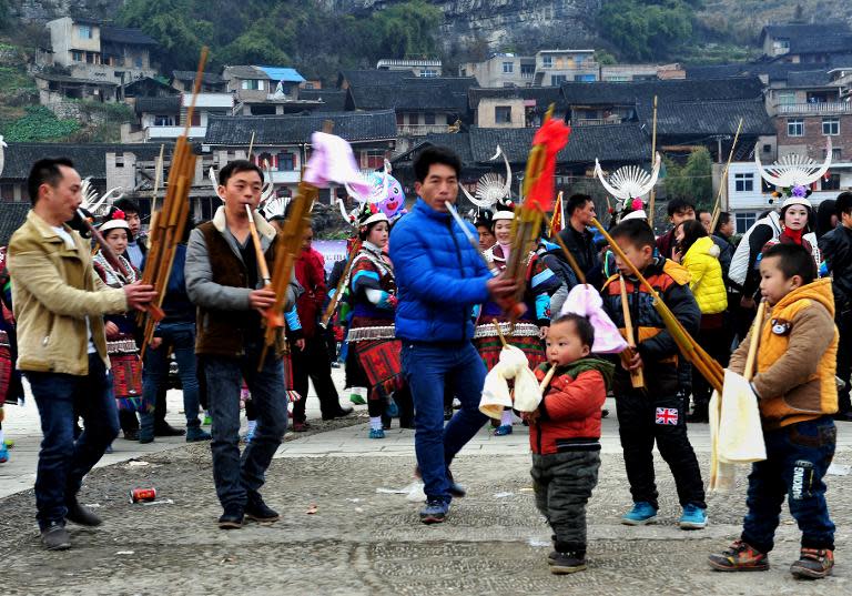 People celebrate the Reed Pipe Festival of the Miao ethnic group, in Zhouxi township, Kaili, southwest China's Guizhou province, on February 19, 2014