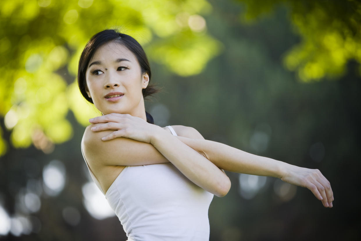 Asian girl stretching for exercise - Horizontal Closeup