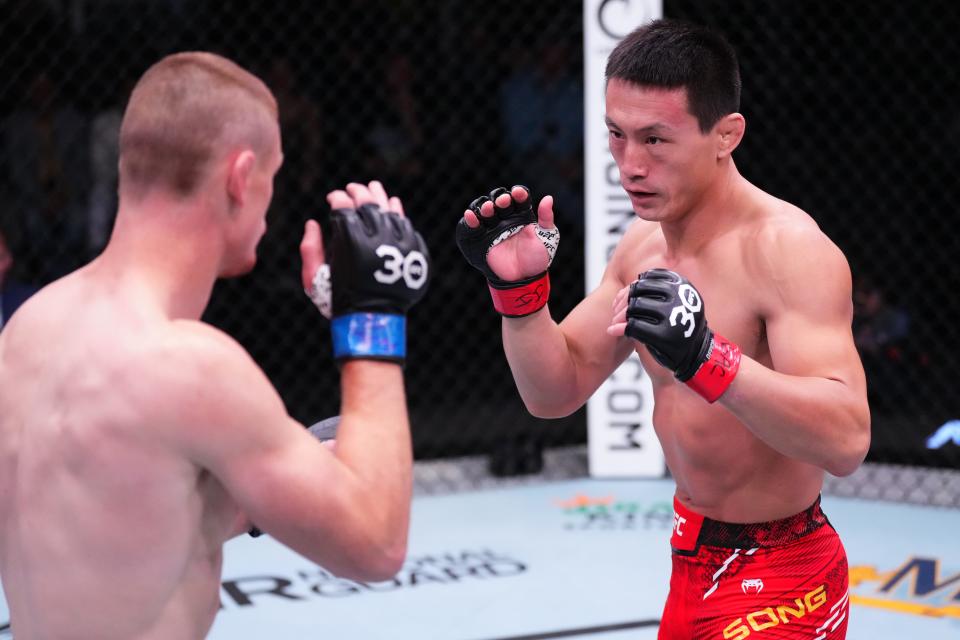 LAS VEGAS, NEVADA - DECEMBER 09: (R-L) Song Kenan of China battles Kevin Jousset of France in a welterweight fight during the UFC Fight Night event at UFC APEX on December 09, 2023 in Las Vegas, Nevada. (Photo by Jeff Bottari/Zuffa LLC via Getty Images)