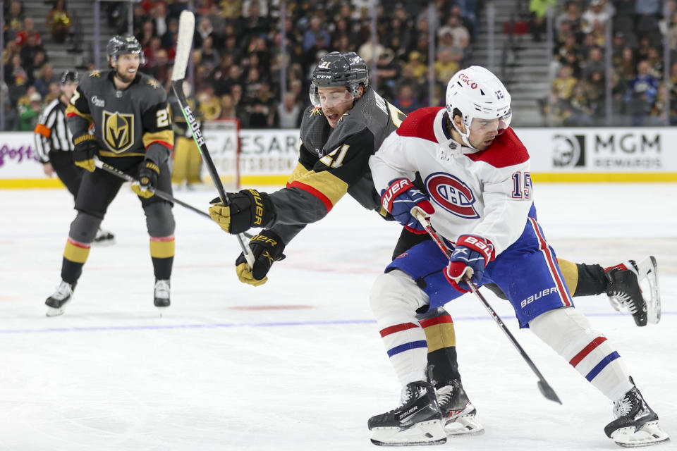Vegas Golden Knights center Brett Howden (21) collides with Montreal Canadiens center Alex Newhook (15) during the second period of an NHL hockey game, Monday, Oct. 30, 2023, in Las Vegas. (AP Photo/Ian Maule)