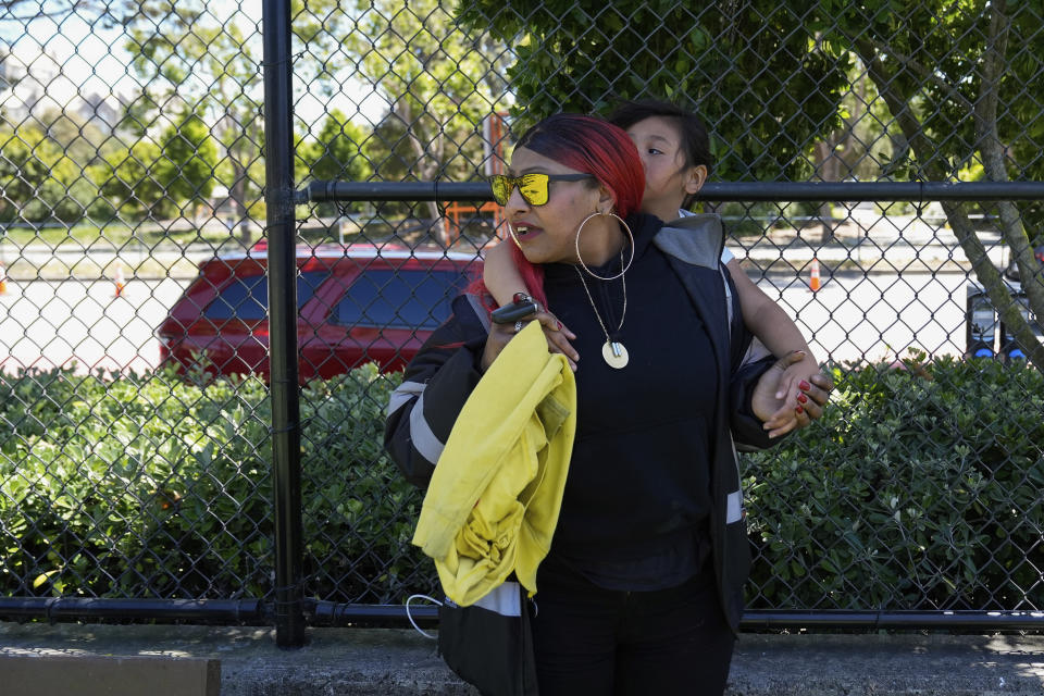 Teniah Tercero gives her daughter Rojelia, 7, a piggyback ride while at a park Thursday, May 23, 2024, in San Francisco. (AP Photo/Godofredo A. Vásquez)