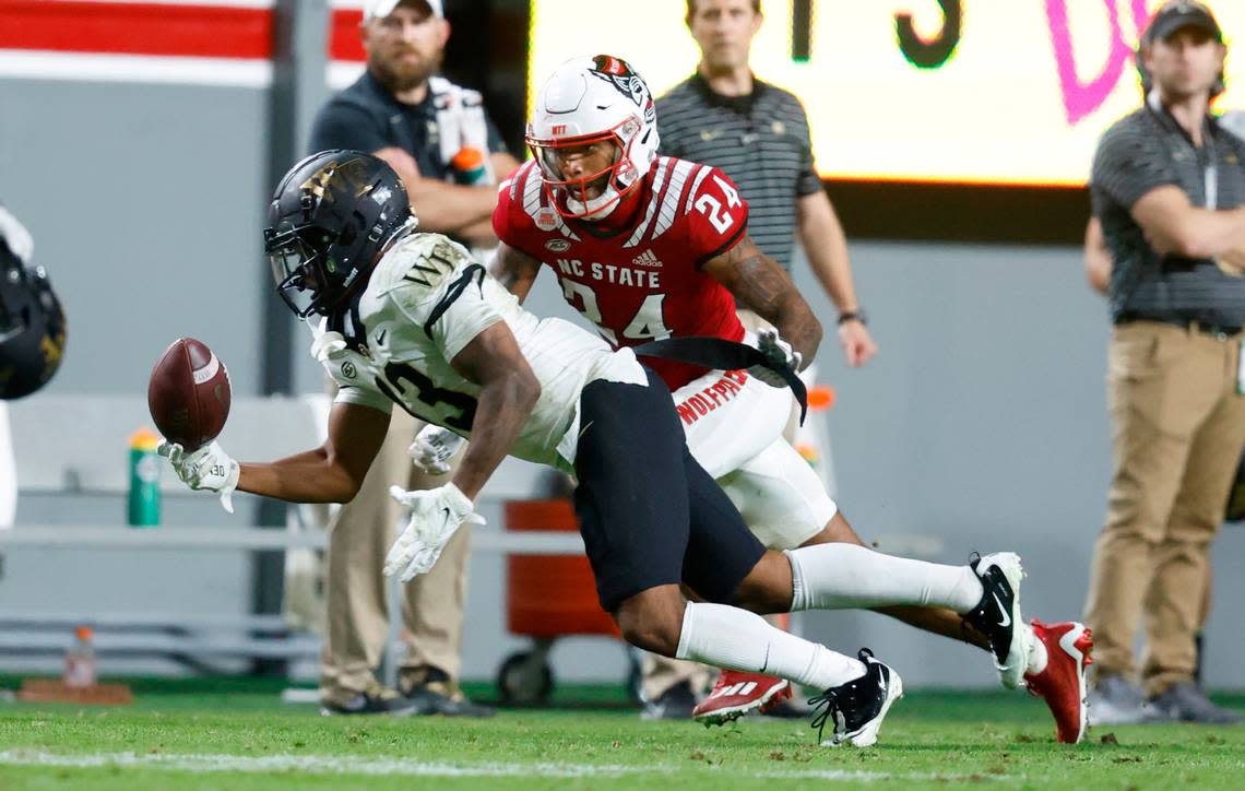 Wake Forest wide receiver Ke’Shawn Williams (13) makes the reception as N.C. State cornerback Derrek Pitts Jr. (24) defends during the second half of N.C. State’s 30-21 victory over Wake Forest at Carter-Finley Stadium in Raleigh, N.C., Saturday, Nov. 5, 2022.