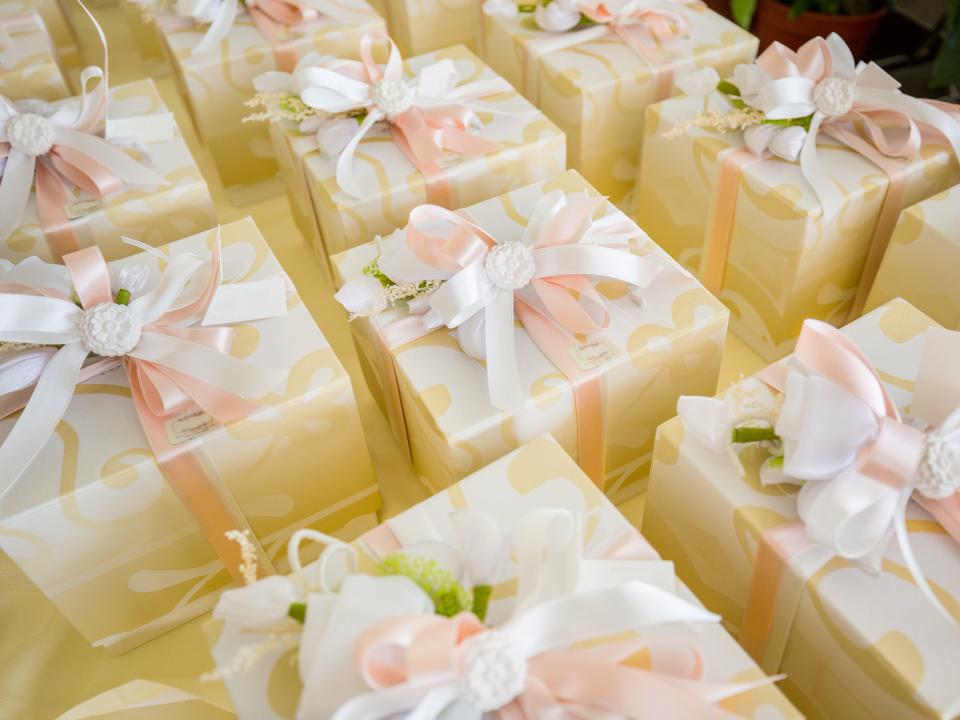 Arrangement of gold wedding favor gift boxes with pink and white bows