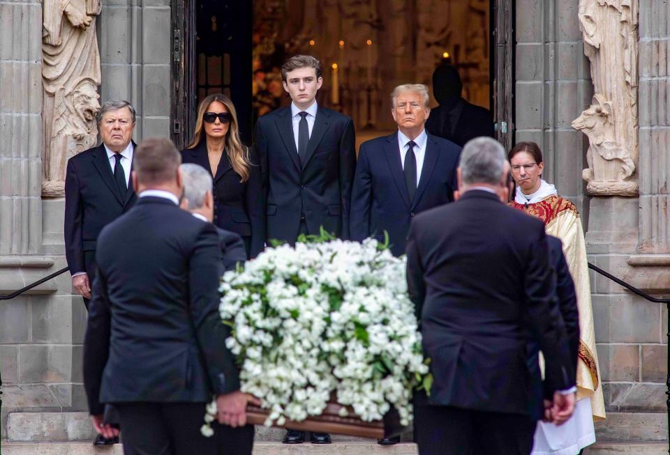 Viktor Knavs (from left) Melania Trump, Barron Trump, former President Donald Trump, and Bethesda-by-the-Sea Rector the Rev. Tim Schenck await the arrival of the casket of Amalia Knavs at the church on Thursday January 18, 2024. Barron Trump will be an at large delegate from Florida at the Republican National Convention in July.