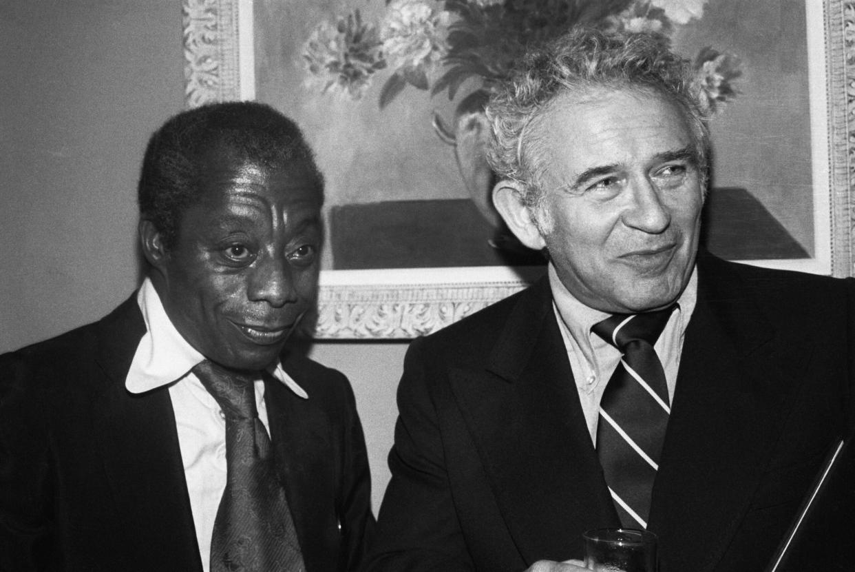 Authors James Baldwin (left) and Norman Mailer at a reception of the American Civil Liberties Union in New York City avowing their support for First Amendment rights guaranteed under the Constitution while under heavy fire for upholding Nazi rights to speak at Skokie, Illinois. (Credit: Getty Images)