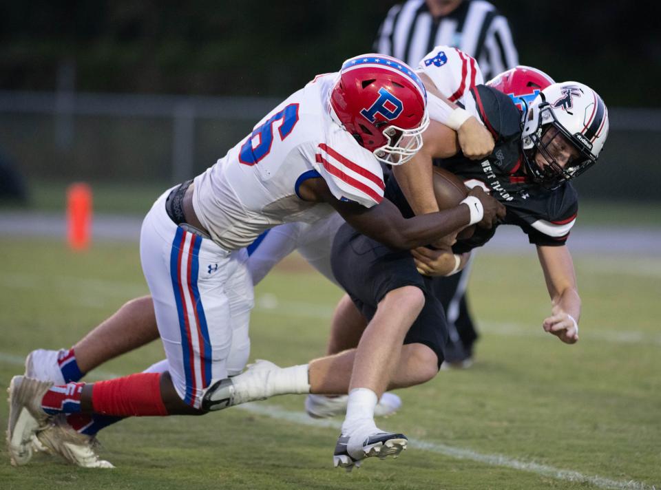 Tylon Lee (6) and Jackson Ward (42) sack quarterback John Nicholas (9) during the Pace vs West Florida football game at West Florida High School in Pensacola on Friday, Sept. 8, 2023.