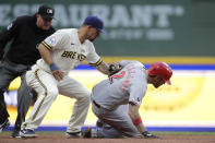 Cincinnati Reds' Nick Castellanos (2) steals second base past the tag of Milwaukee Brewers' Jace Peterson, center, during the second inning of a baseball game Monday, June 14, 2021, in Milwaukee. (AP Photo/Aaron Gash)