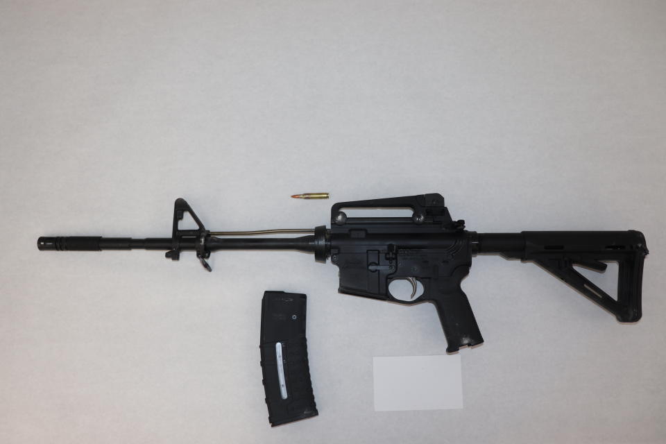 This image provided by the St. Louis Metropolitan Police Department shows an AR-15-style rifle used by a 19-year-old gunman who killed a teacher and a 15-year-old girl at a St. Louis high school on Monday, Oct. 24, 2022. The gunman was armed with an AR-15-style rifle and what appeared to be more than 600 rounds of ammunition, Police Commissioner Michael Sack said Tuesday, Oct. 25, 2022. (St. Louis Metropolitan Police Department via AP)