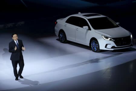 BYD Co Ltd Chairman and President Wang Chuanfu speaks next to its hybrid electric car 'Qin' at BYD Dreamcast conference in Beijing, China, April 11, 2016. REUTERS/Kim Kyung-Hoon