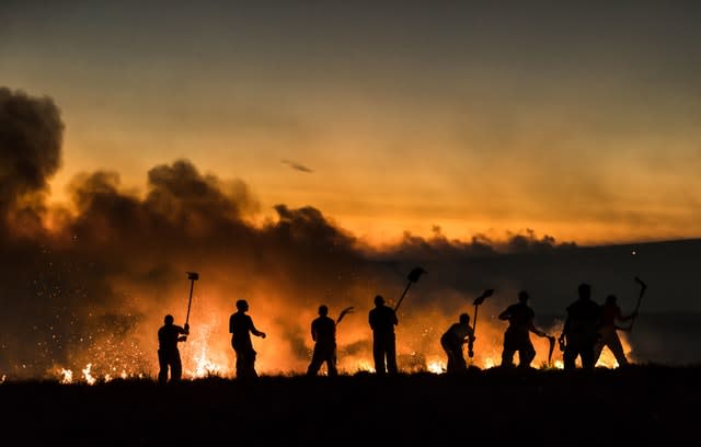 Firefighters tackle a wildfire on Winter Hill in June 2018