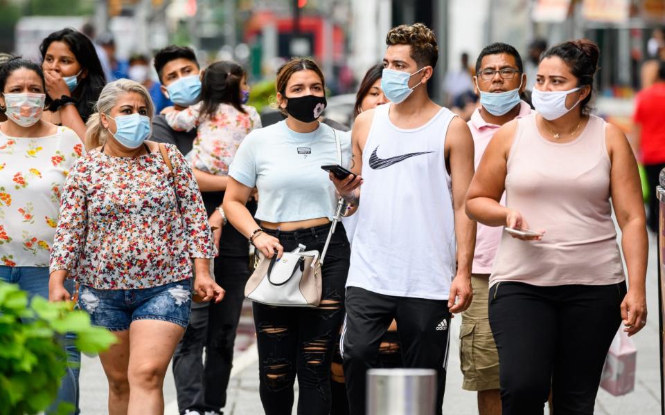 People wear protective face masks in Times Square  - Getty Images North America 