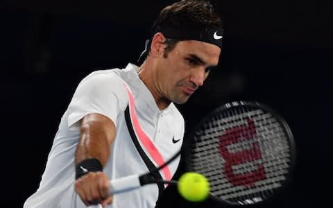 Switzerland's Roger Federer hits a return against France's Richard Gasquet during their men's singles third round match on day six of the Australian Open tennis tournament in Melbourne on January 20, 2018