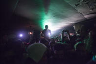 A fan stands on the bar to get a better view of the performers. Photo by Niña Sandejas.