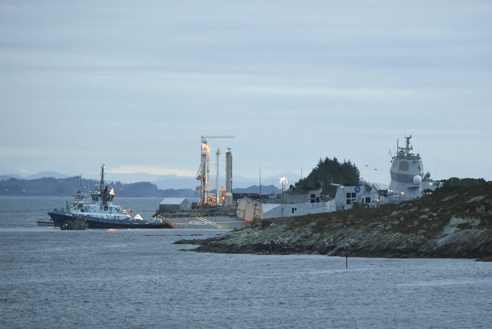 The Norwegian frigate KNM Helge Ingstad takes on water after a collision with the tanker Sola TS, in Oygarden, Norway, Thursday Nov. 8, 2018. Norway's military says the 127-man crew on a Navy frigate has been evacuated after the ship was rammed by a Malta-flagged tanker while docked in a Norwegian harbor. Seven people were slightly injured. (Marit Hommedal/NTB Scanpix via AP)