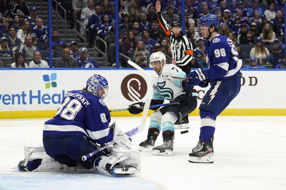 Tampa Bay Lightning goaltender Andrei Vasilevskiy (88) makes a save on a shot by Seattle Kraken right wing Jordan Eberle (7) during the third period of an NHL hockey game Friday, Nov. 26, 2021, in Tampa, Fla. Defending for the Lightning is Mikhail Sergachev (98). (AP Photo/Chris O'Meara)