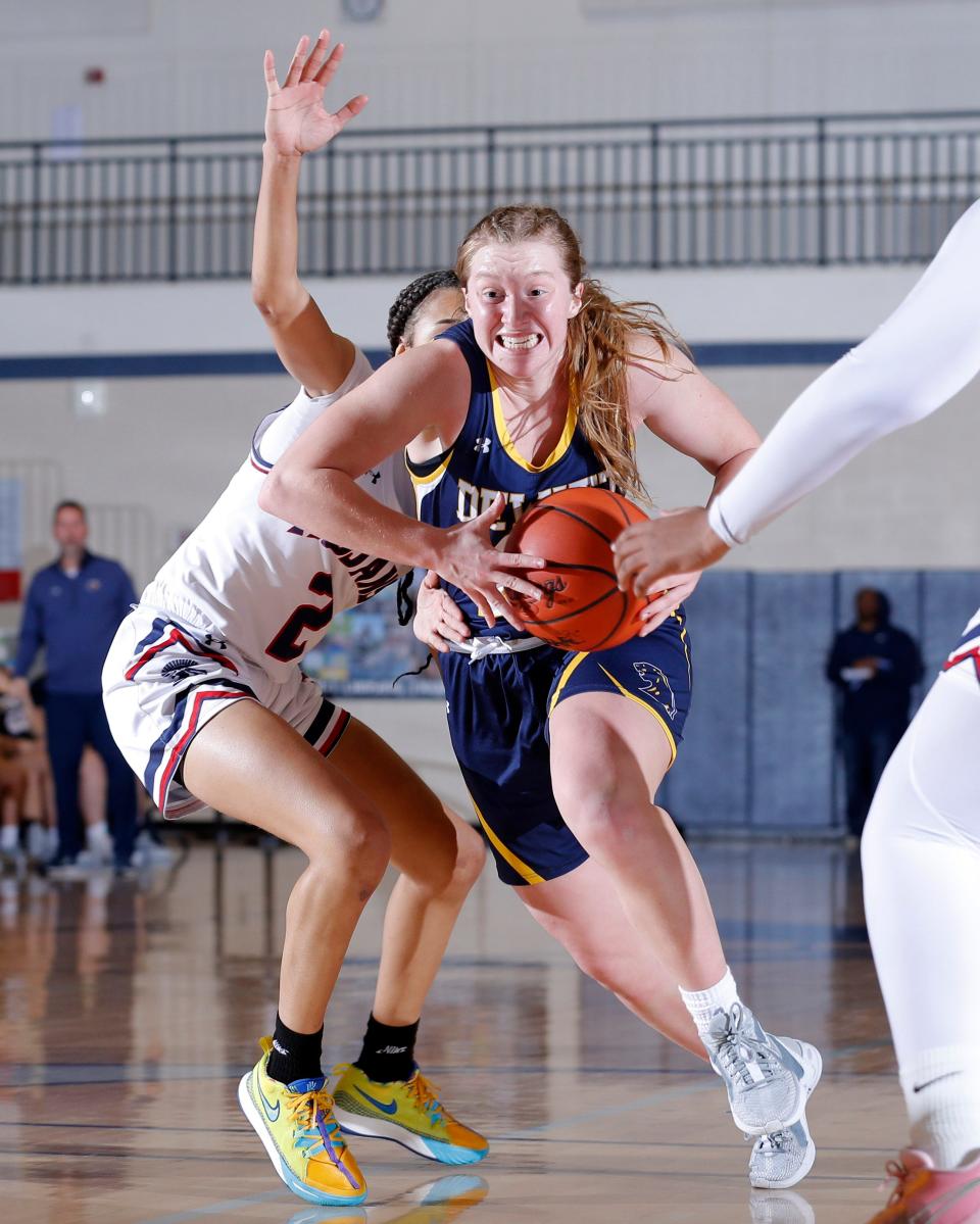 DeWitt's Madi Uyl drives against East Lansing's Ariyana James, Friday, Jan. 19, 2024, in East Lansing.